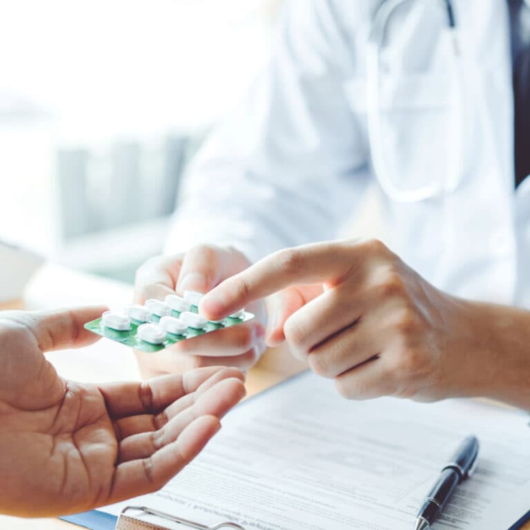 Doctor handing medication to patient
