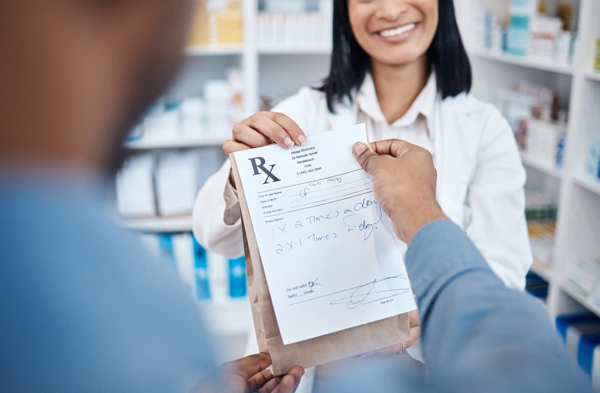 Pharmacist handing prescription